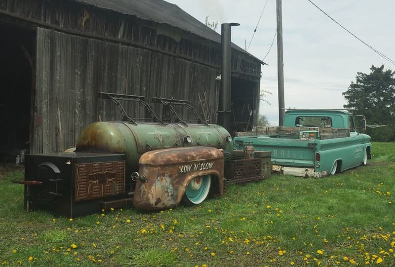 Hickory Lane's patina air-ride smoker in front of an old barn