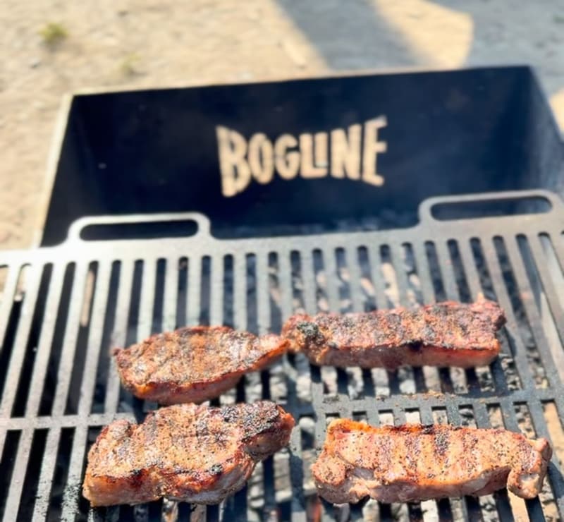 Steaks over live fire on a Bog Line grill